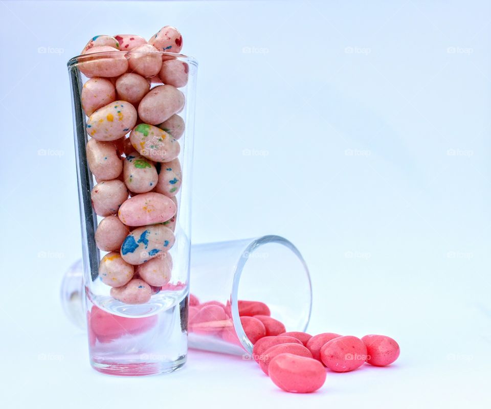 Jelly Belly jelly beans in shot glasses on a white background