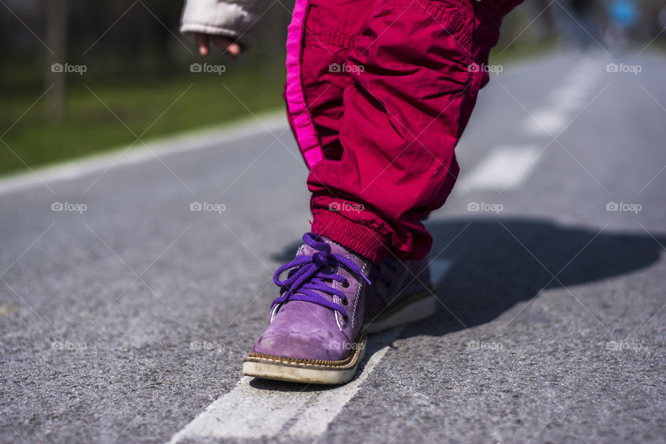 kid playing on road