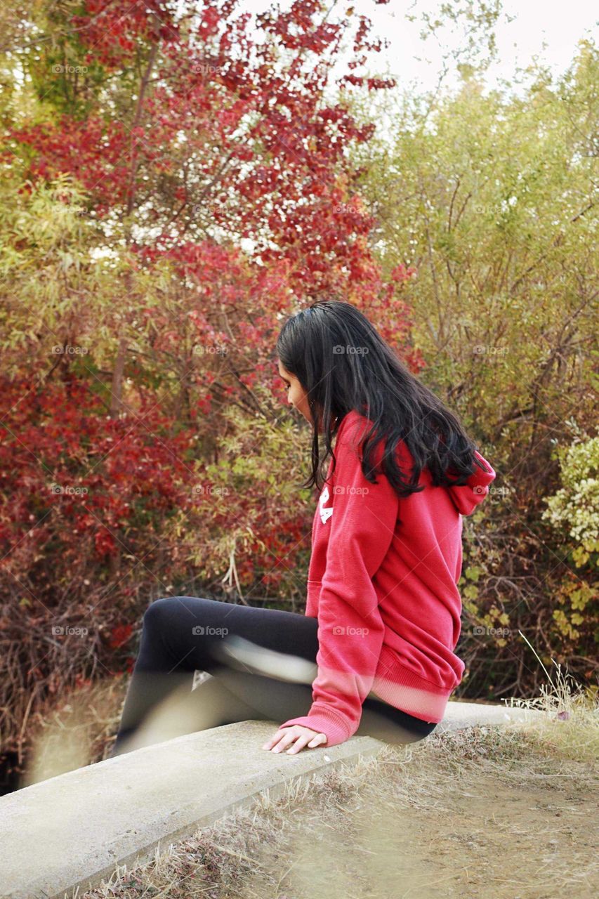 Girl sitting on a ledge