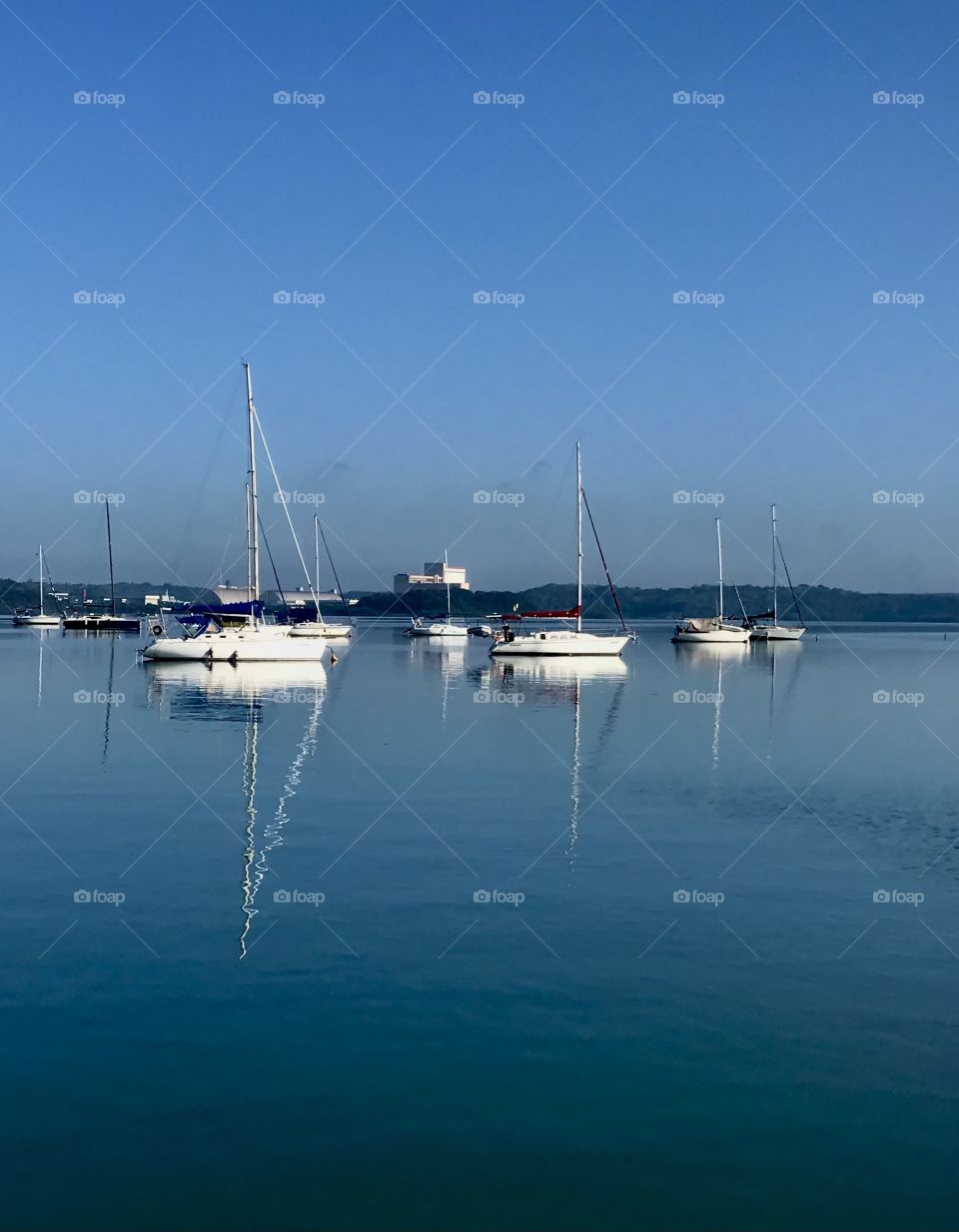 reflection of sailboats in Baia de Todos os Santos, Bahia, Brazil