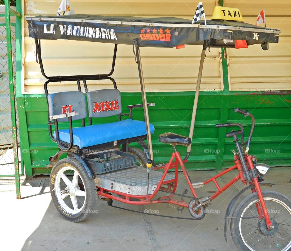 Cycling Week: Do you love your bicycle? A bicycle used as a mode of transportation, Taxi rests in the shade waiting for passengers 