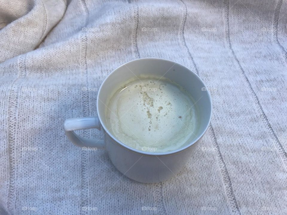 This is a cup of white hot chocolate. All are in the shade of a white to light gray color.