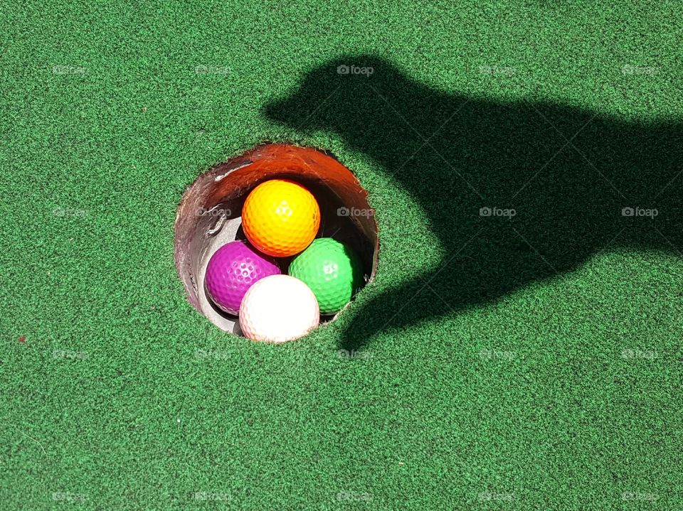 Green Turf and colorful golf balls