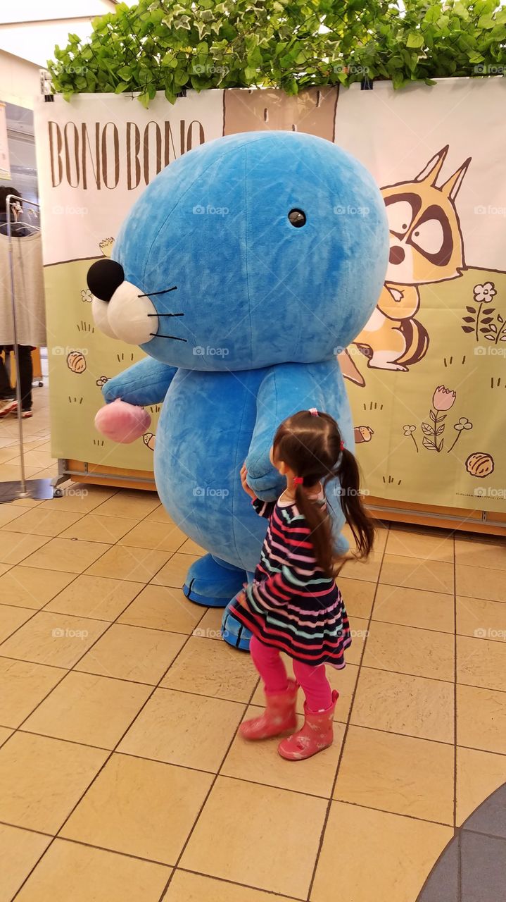 Little girl playing with cartoon character