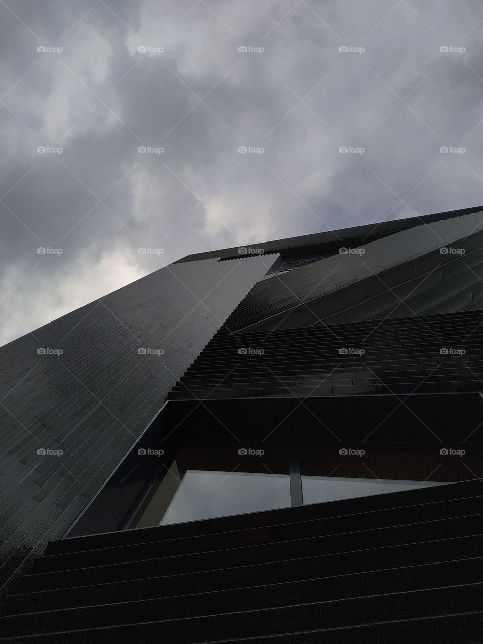 Modern architecture. View from below. Cloudy sky.