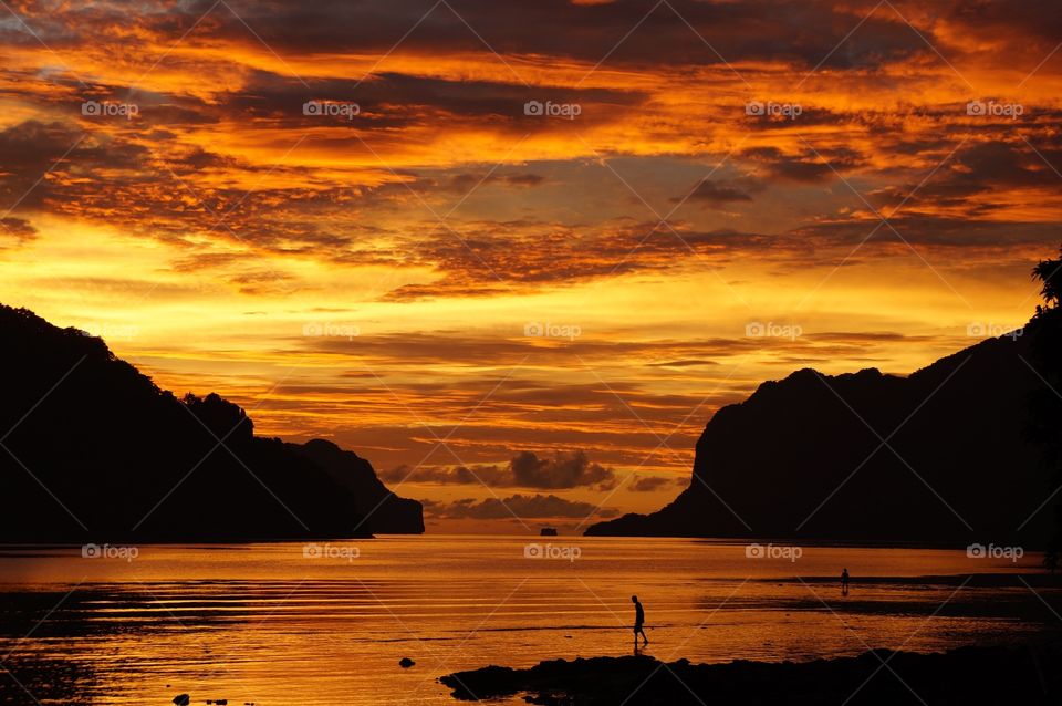 View of dramatic sky over Bacuit bay at sunset