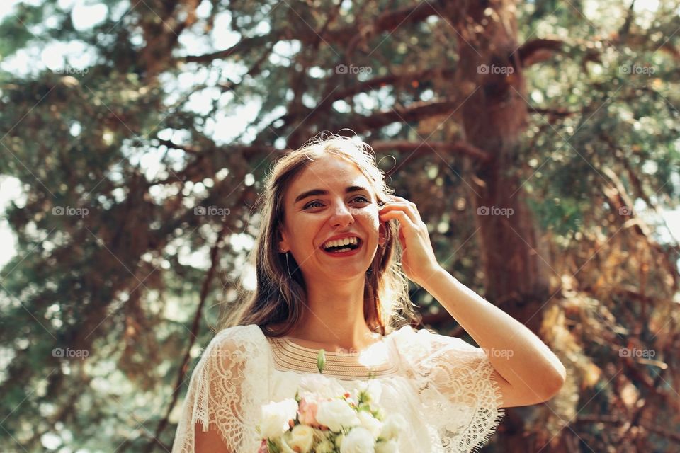 Bride smiling while straightening her hair