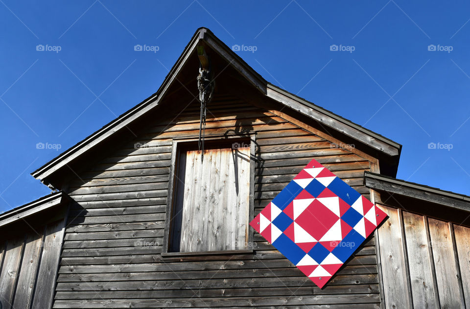 Roof peak of a rustic barn with Amish quilt