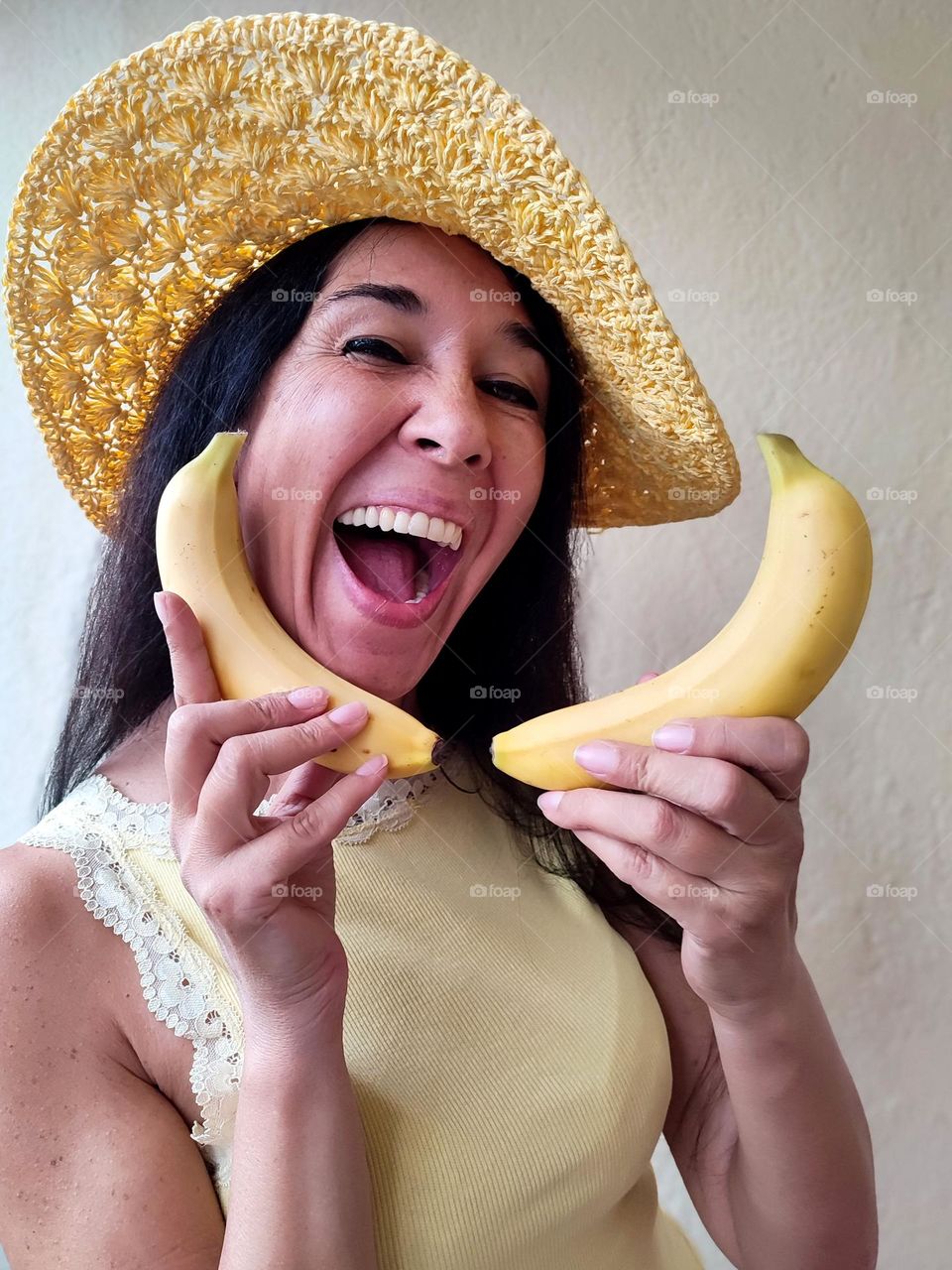 Funny Portrait of Beautiful Smiling Woman with bananas