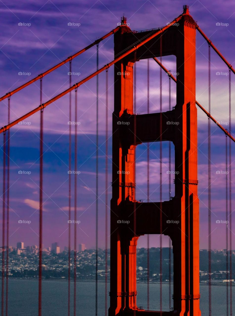 Golden Gate Bridge Scene at Sunset - The Golden Gate overlooking it's protégé as the sun sets, alluminating is iron red color