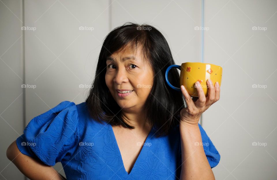 A portrait of a woman holding a cup