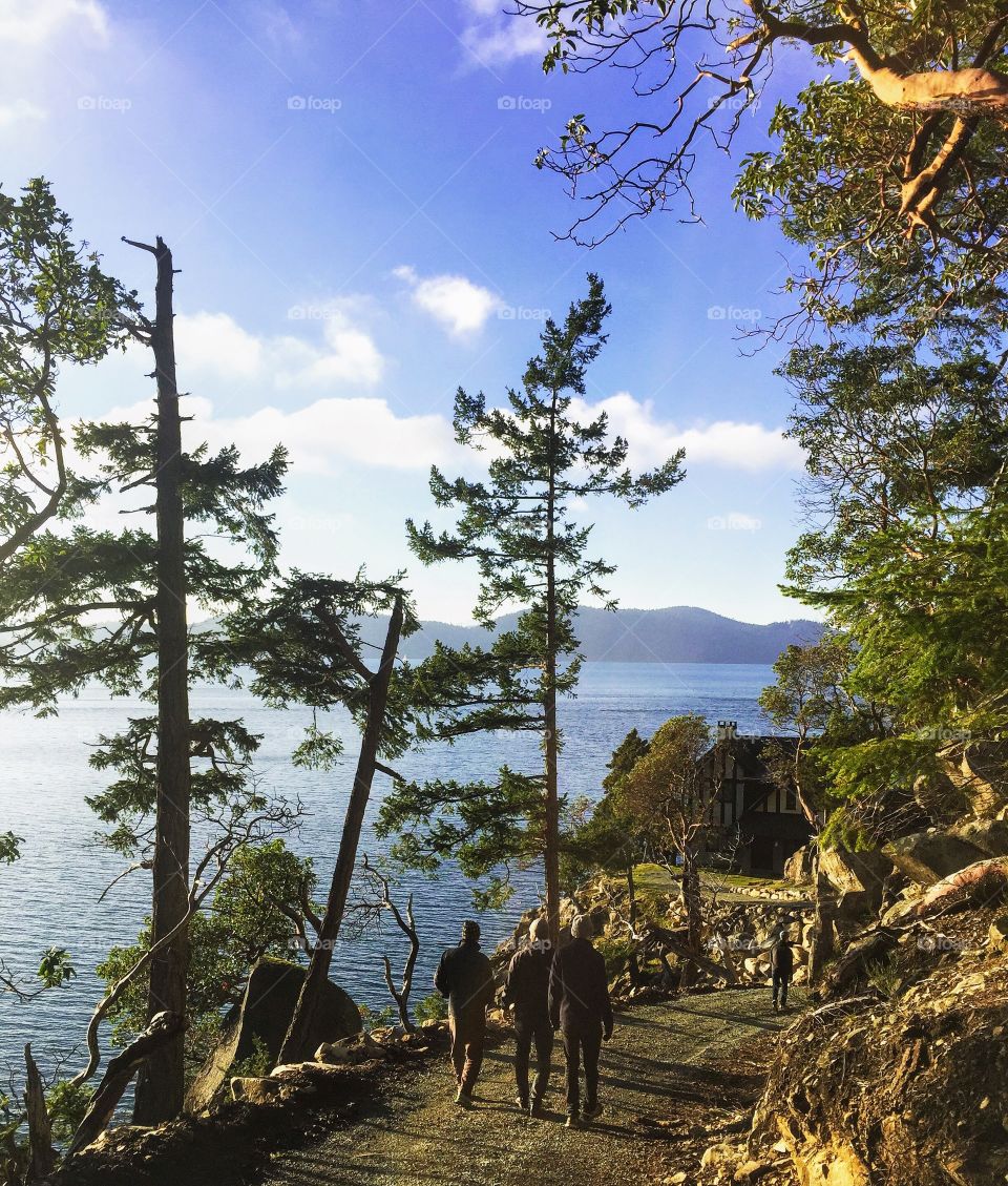 A few friends walking towards a beautiful home on a winters day along the shores of Saturna Island, British Columbia, Canada