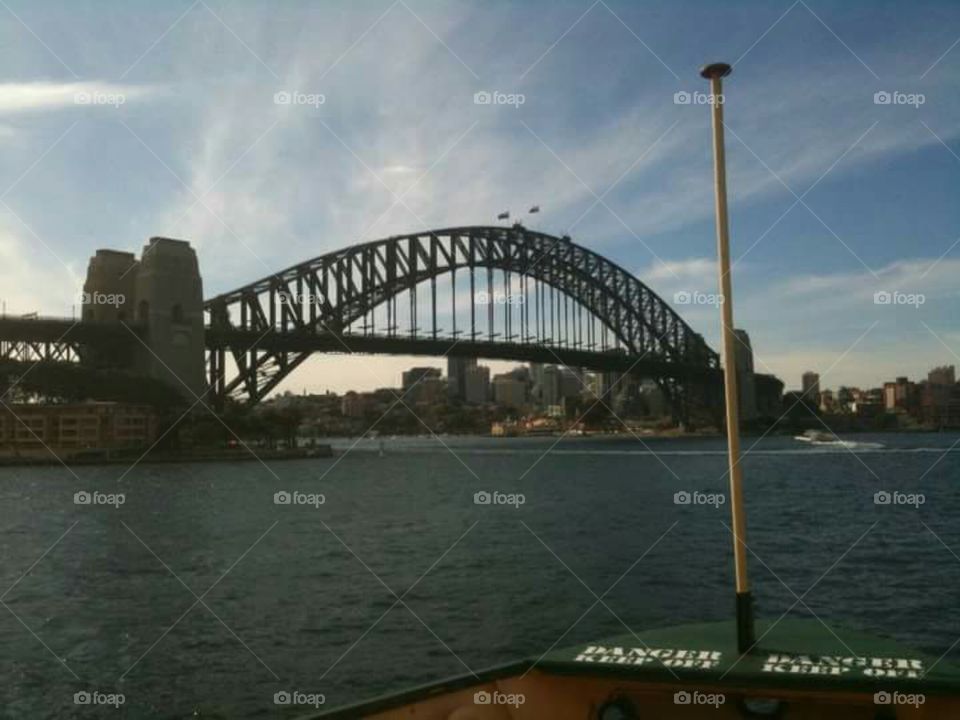 A view of the Sydney Harbour Bridge from the water.