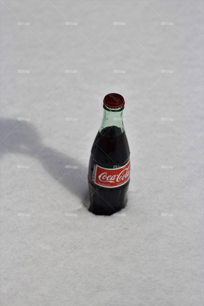 Shadow Play grabbing a Coca Cola with white, smooth snow as background