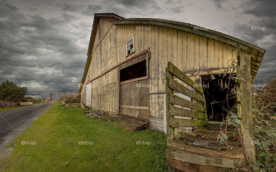 Old wooden barn on side of road