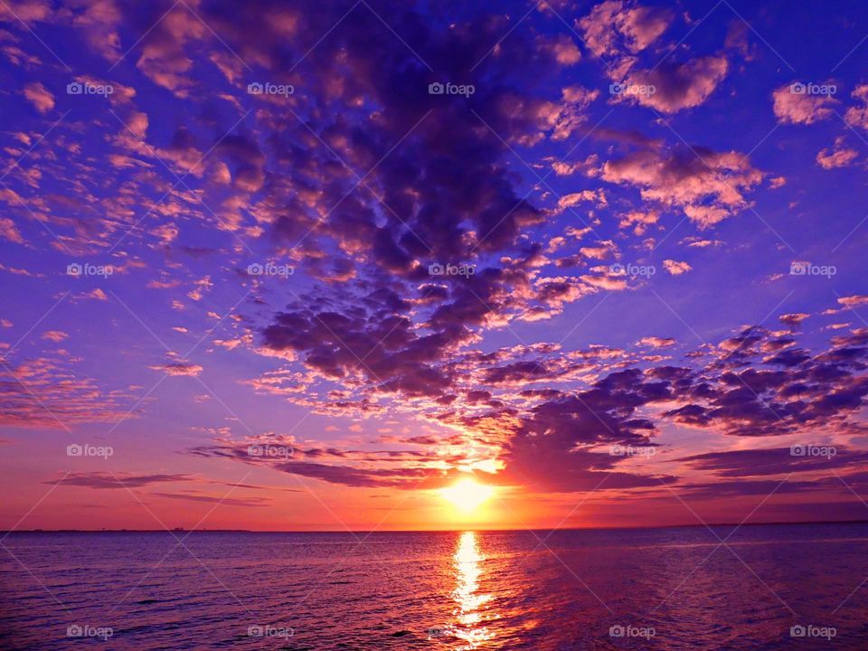 YELLOW AND PURPLE - Vibrant Purple skyline and orange descending sun. Yellow is often associated with happiness, optimism, and energy. Purple can be associated with royalty, wealth, creativity, and even a sense of mystery