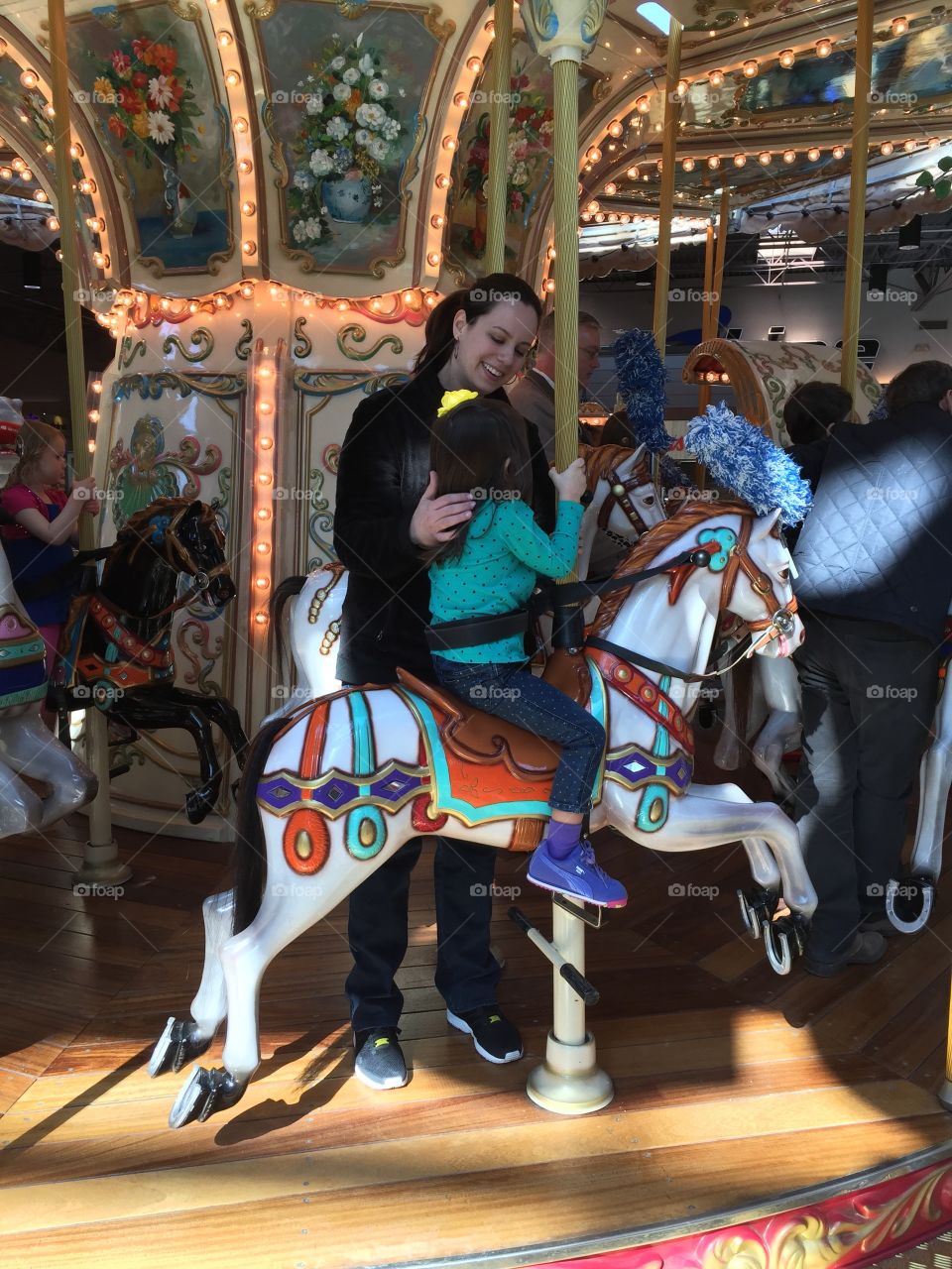 Carousel . Mom and daughter riding the carousel 