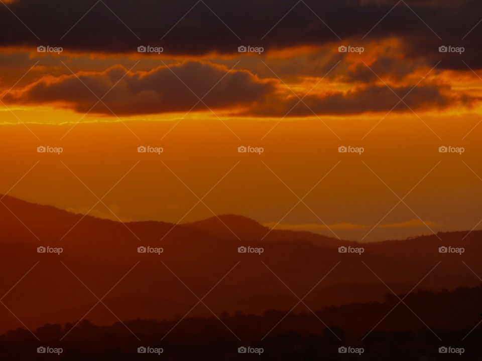 Red sunset across mountains.