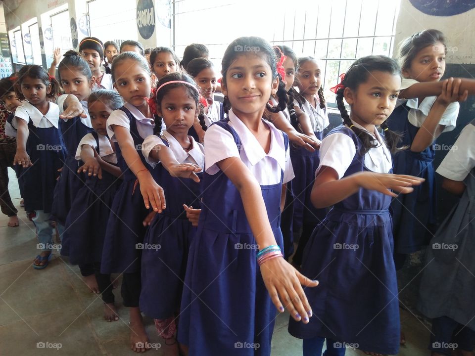 School students standing in a row for prayer