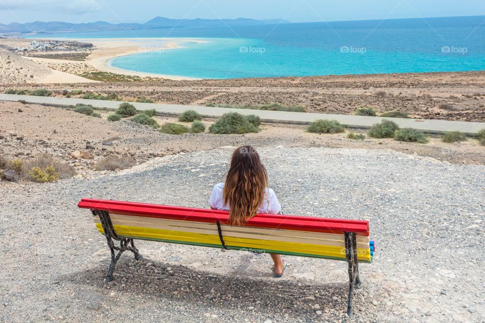 lady resting, sitting on a bench contemplating the view