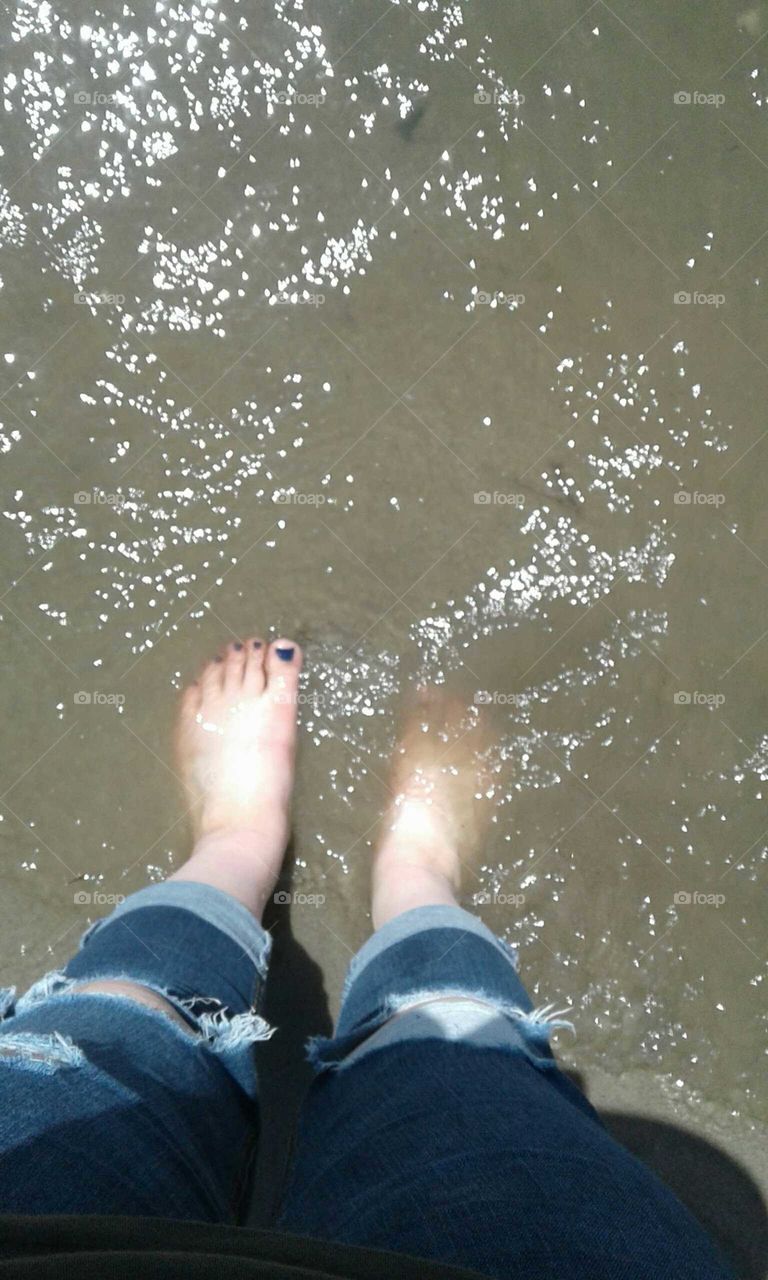 feet in the water. toes in the sand.