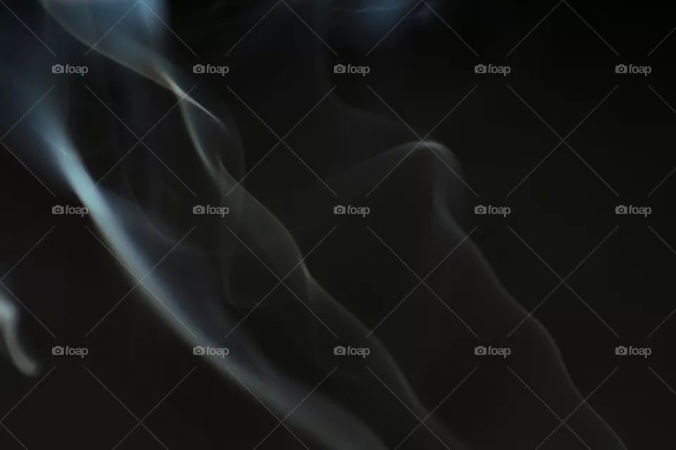 Smoke scented candles on a black background