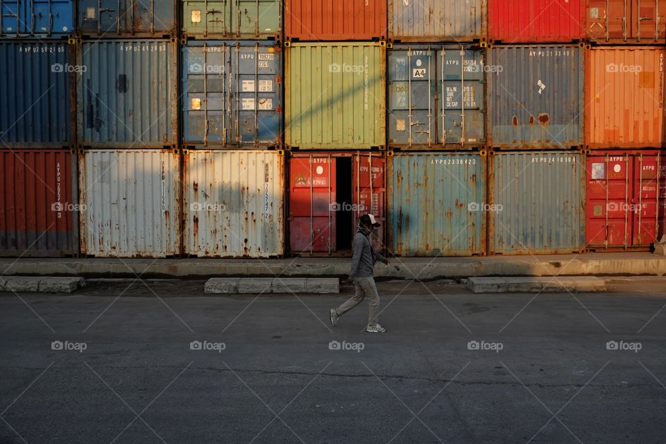 a man wearing mask walking alone in the port of Sunda Kelapa, Jakarta 2020