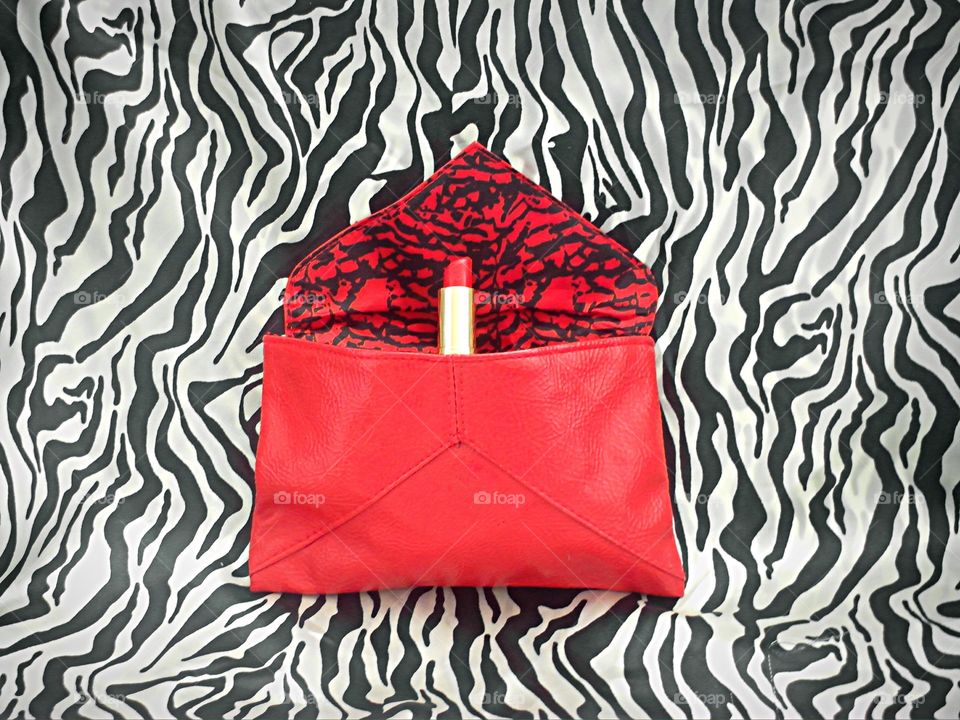 Red lipstick in red bag