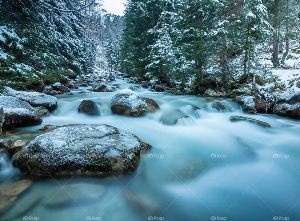 A cold river stream in a snowy landscape