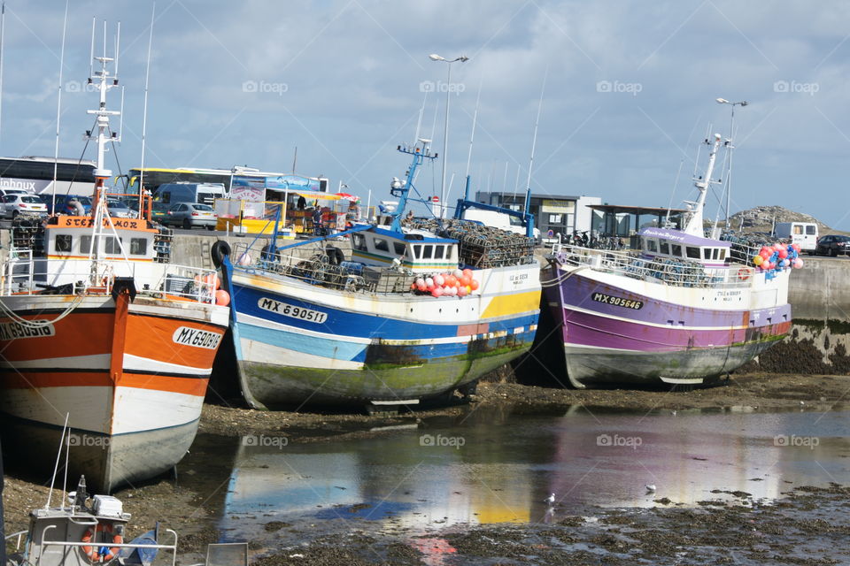 nice colored fisherman boats in a nearly dry harbour