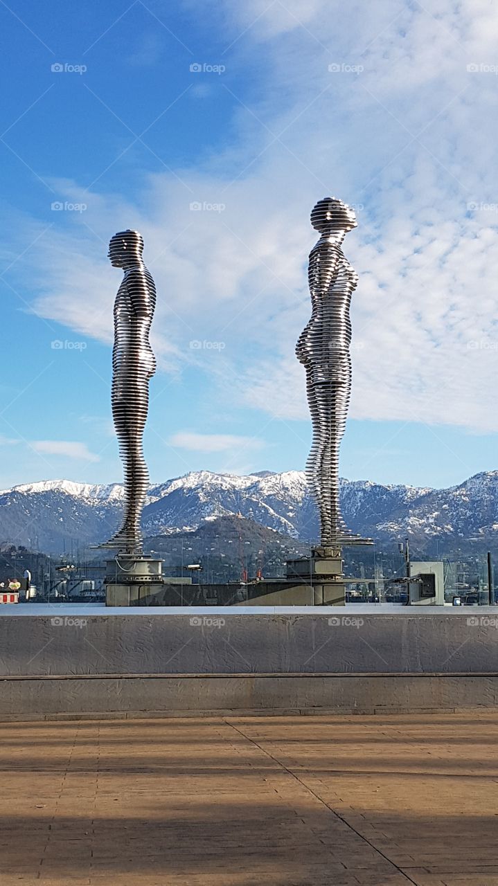 the figure of a man and a woman against the background of the mountains