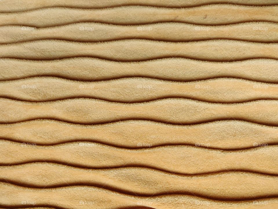 Golden waves on textile.