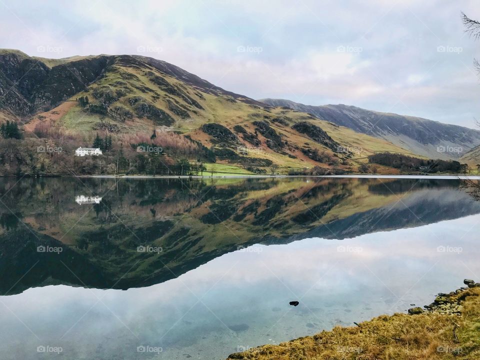 Mirrored fells in Cumbrian lake 