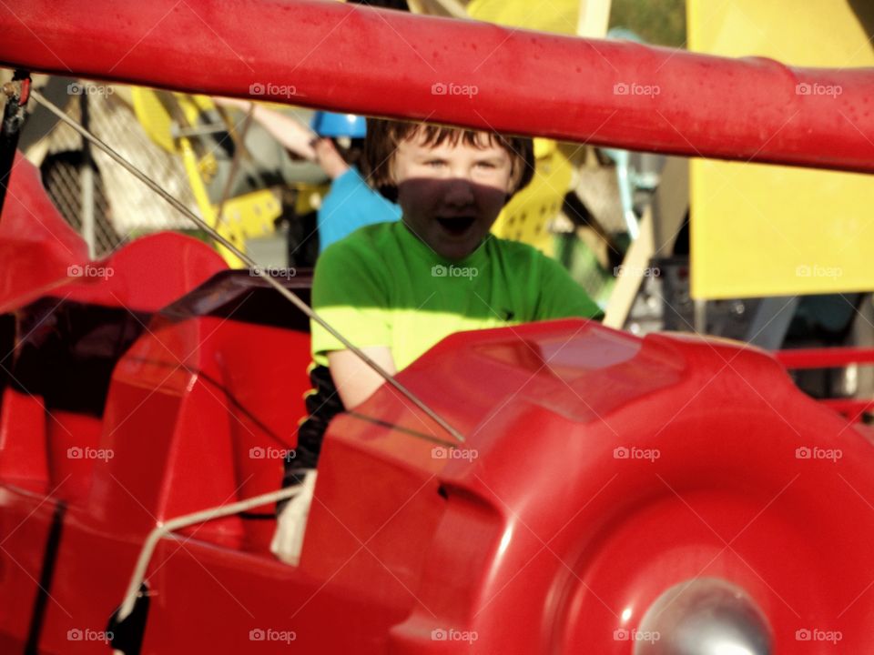 Joyful Boy At An Amusement Park
