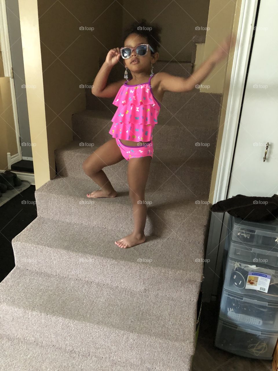 Little girl in bathing suit with sunglasses 