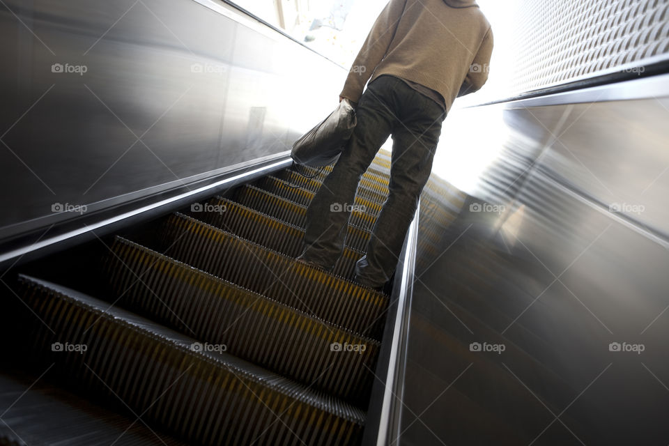 Man going up in escalator 