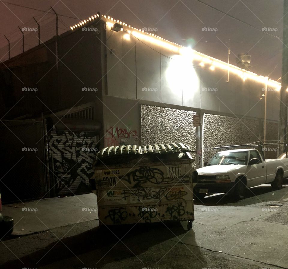 Garbage dumpster awkwardly left in the middle of the street in Oakland California 