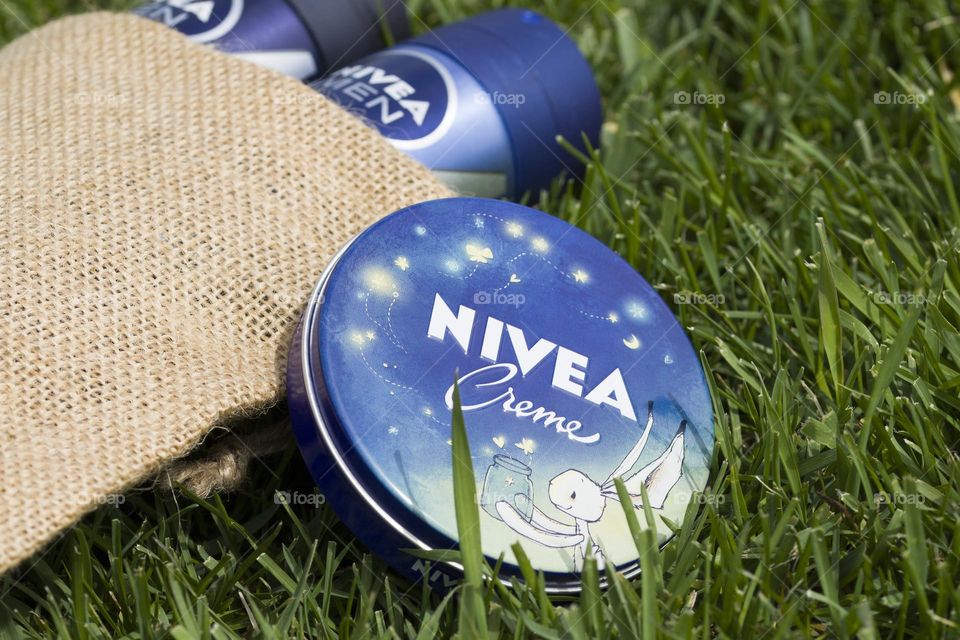 Nivea cream and deodorants on natural background.  Eco-friendly concept