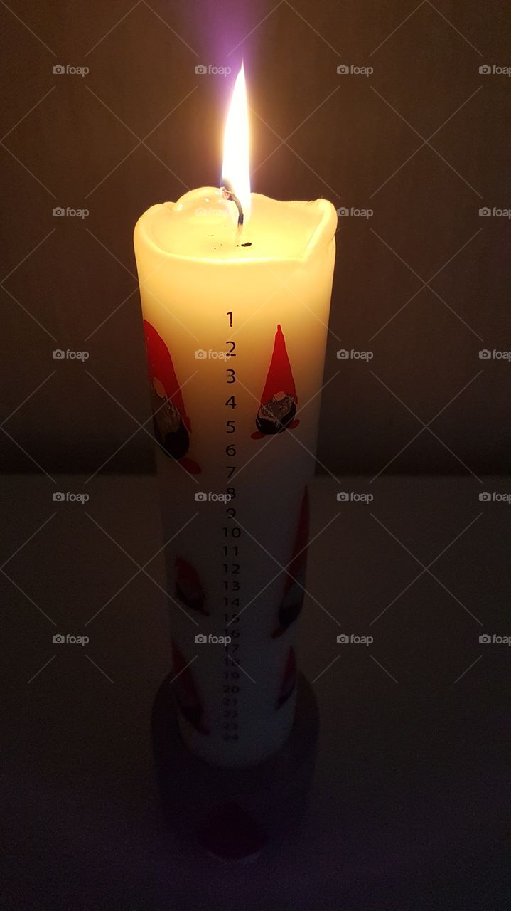 Lit Christmas candle  in the dark , countdown 