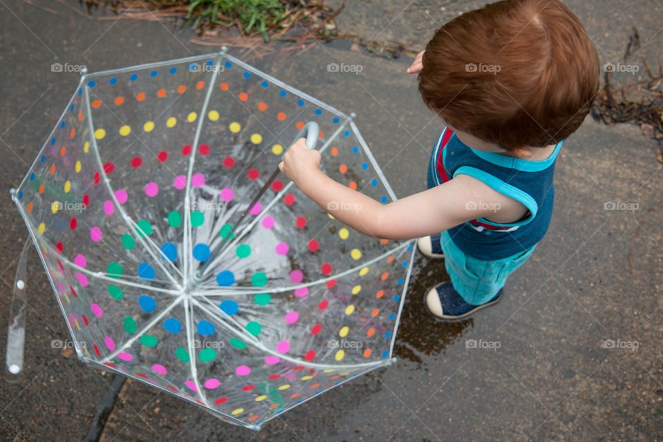 Toddler spinning the umbrella