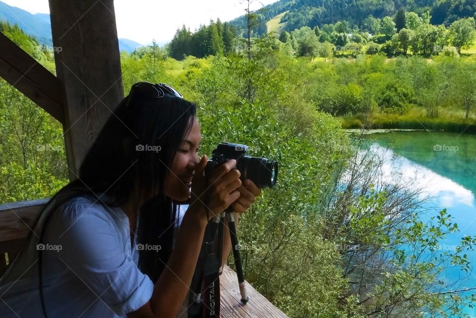 Young woman taking photograph of nature