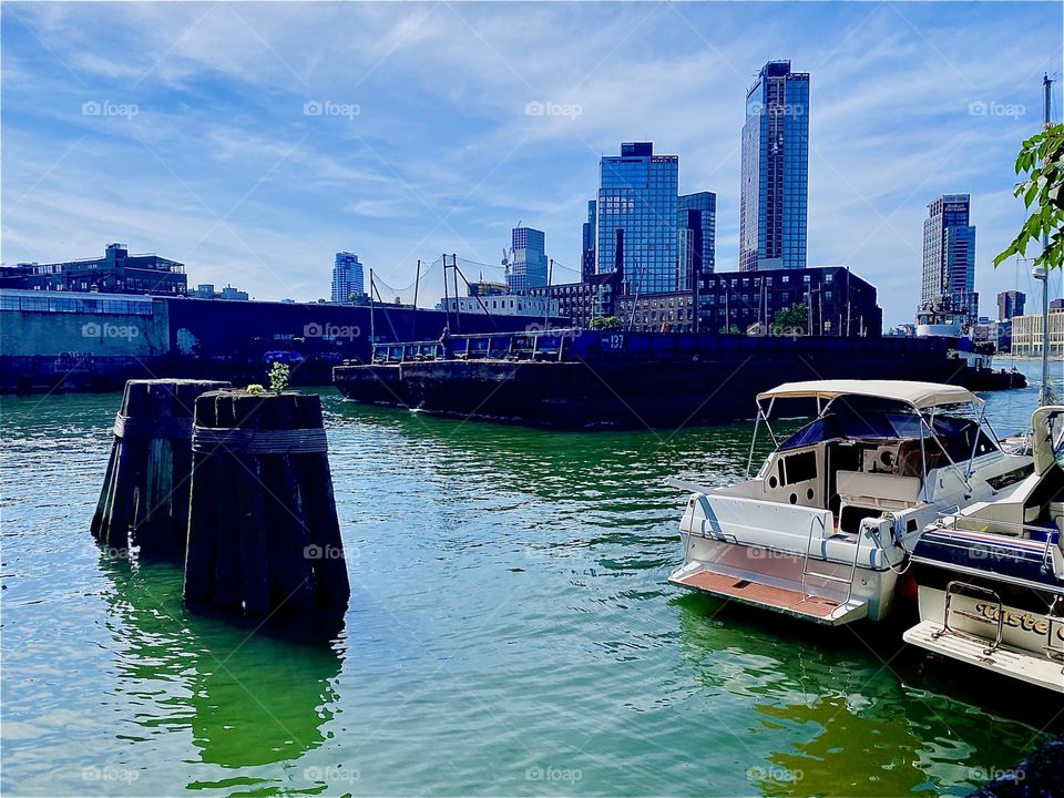 A large barge is slowly making its way towards us on the “East River” here at “Newtown Creek” by the “Pulaski Bridge” in LIC, Queens on a warm Indian summer afternoon in September 2023. Hypnotic Productions