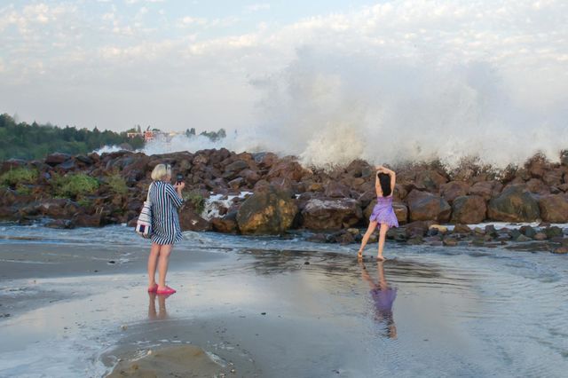 Woman Recording a Video on Stormy Sea