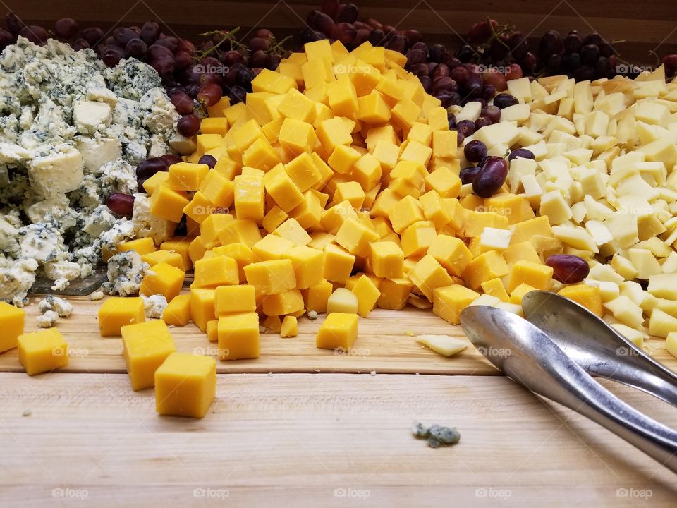 Cheese cubes and serving tongs