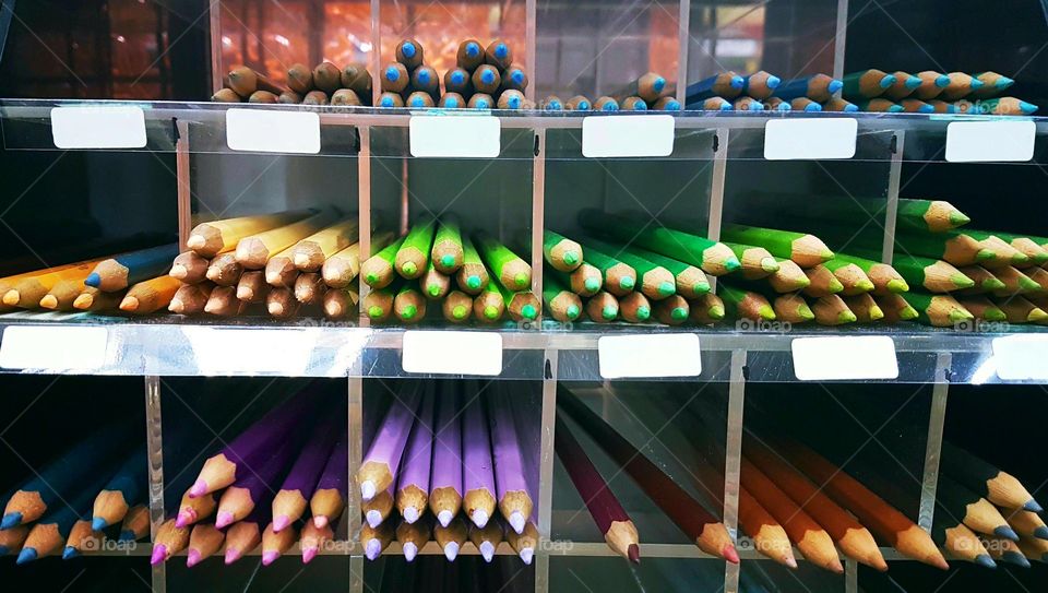 Color pencils on display shelves.