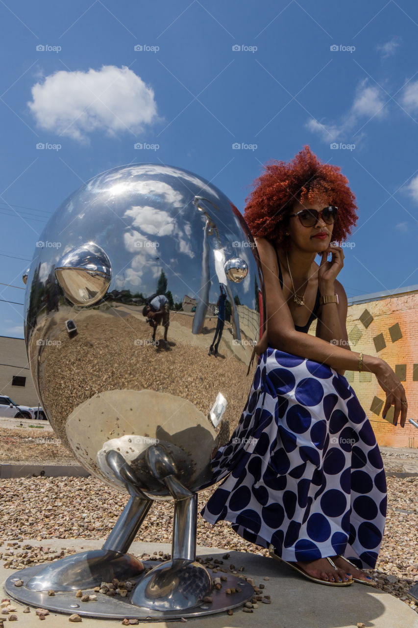 Reflection of a man taking photography of a woman