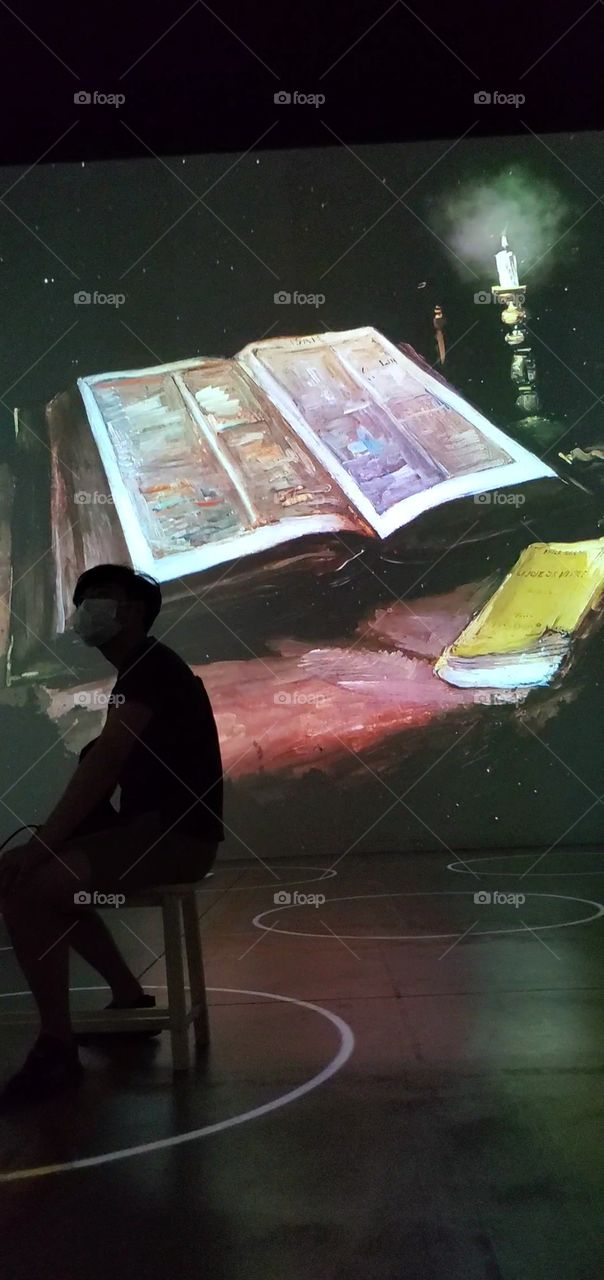 man in front of a canvass