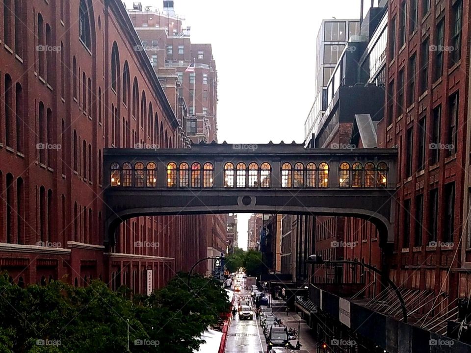 metal footbridge between two buildings, photographed from the highline, Chelsea district, New York City