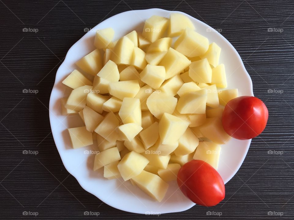 Chopped potatoes with red tomatoes