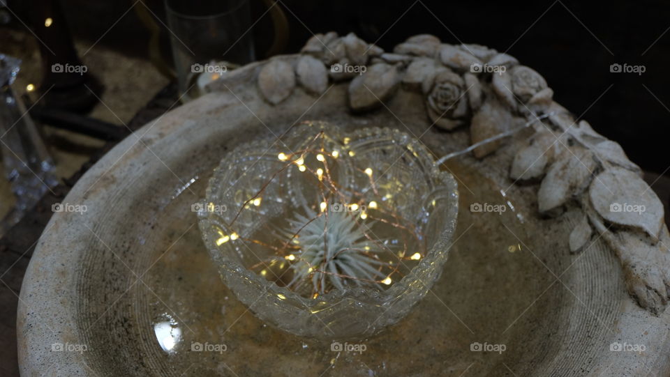 Bird bath for garden repurposed for night decoration.